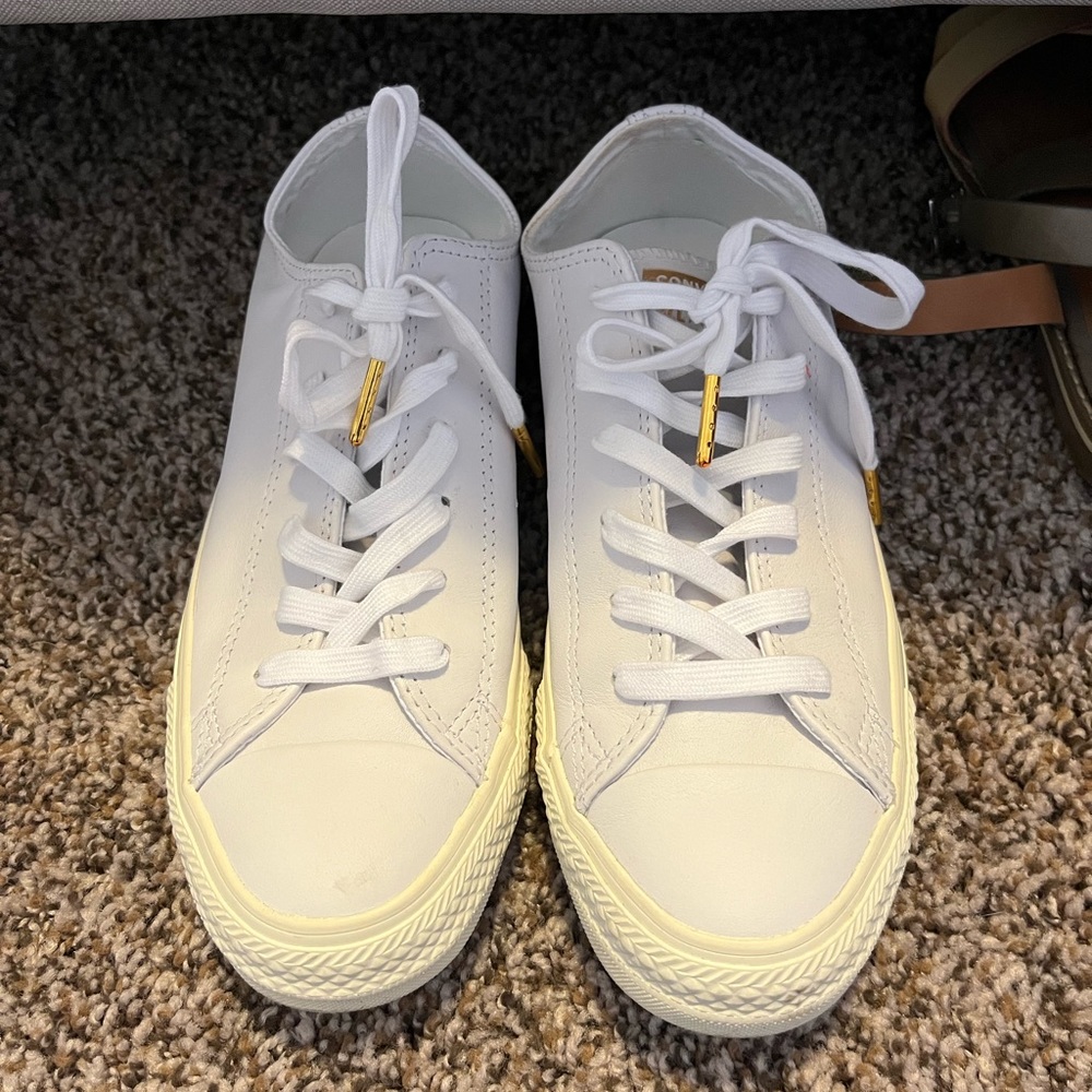 White leather Converse low tops.